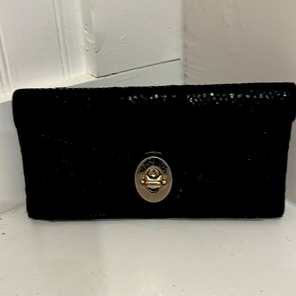 Pre-owned Black Coach wallet w/ blue leather inside. Leather & Fabric outside.